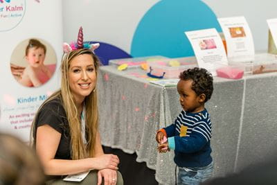 Image showing a Childcare and Education Expo attendee with a child