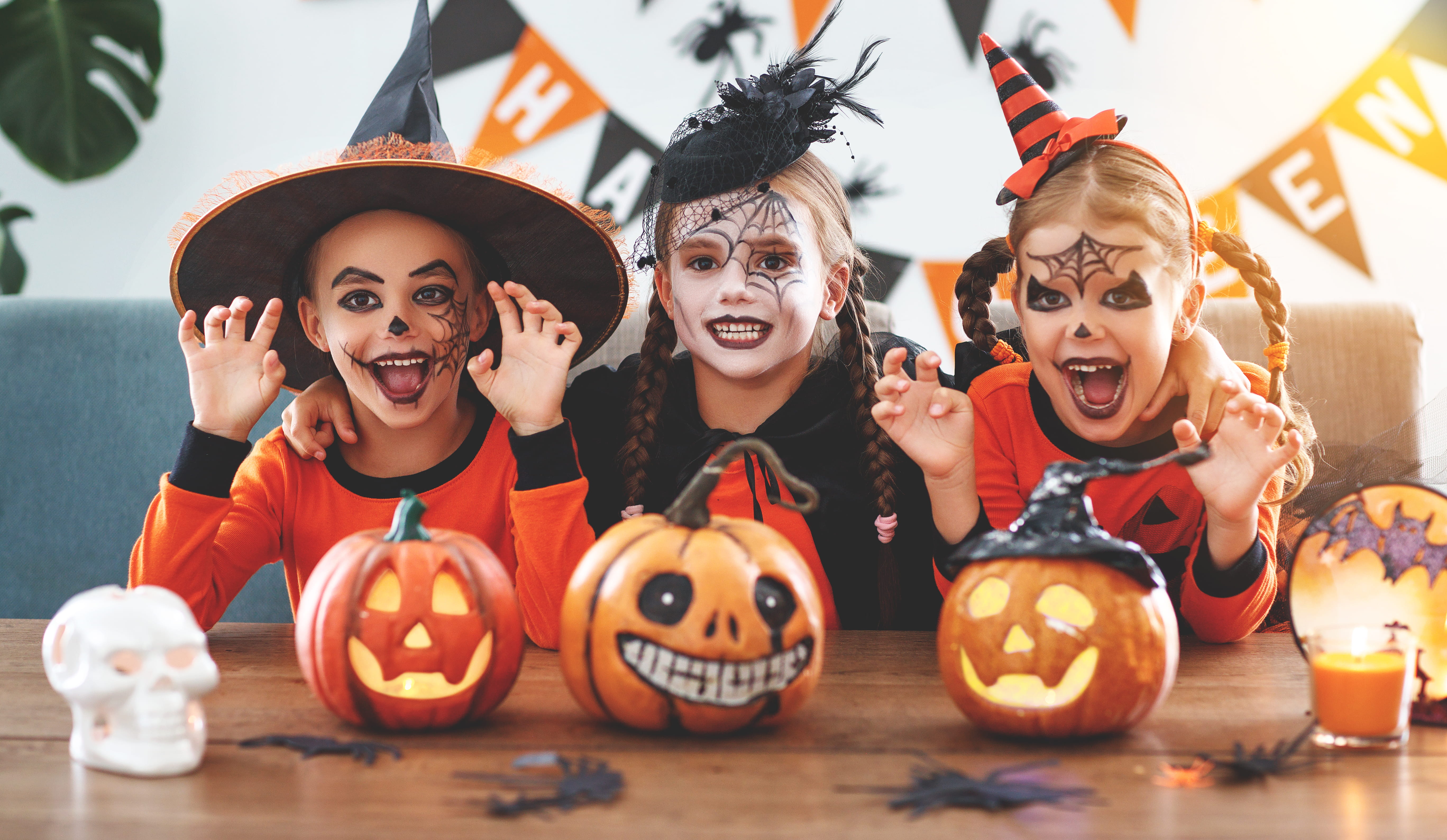 Happy Halloween! A group of children in Halloween costumes and with pumpkins