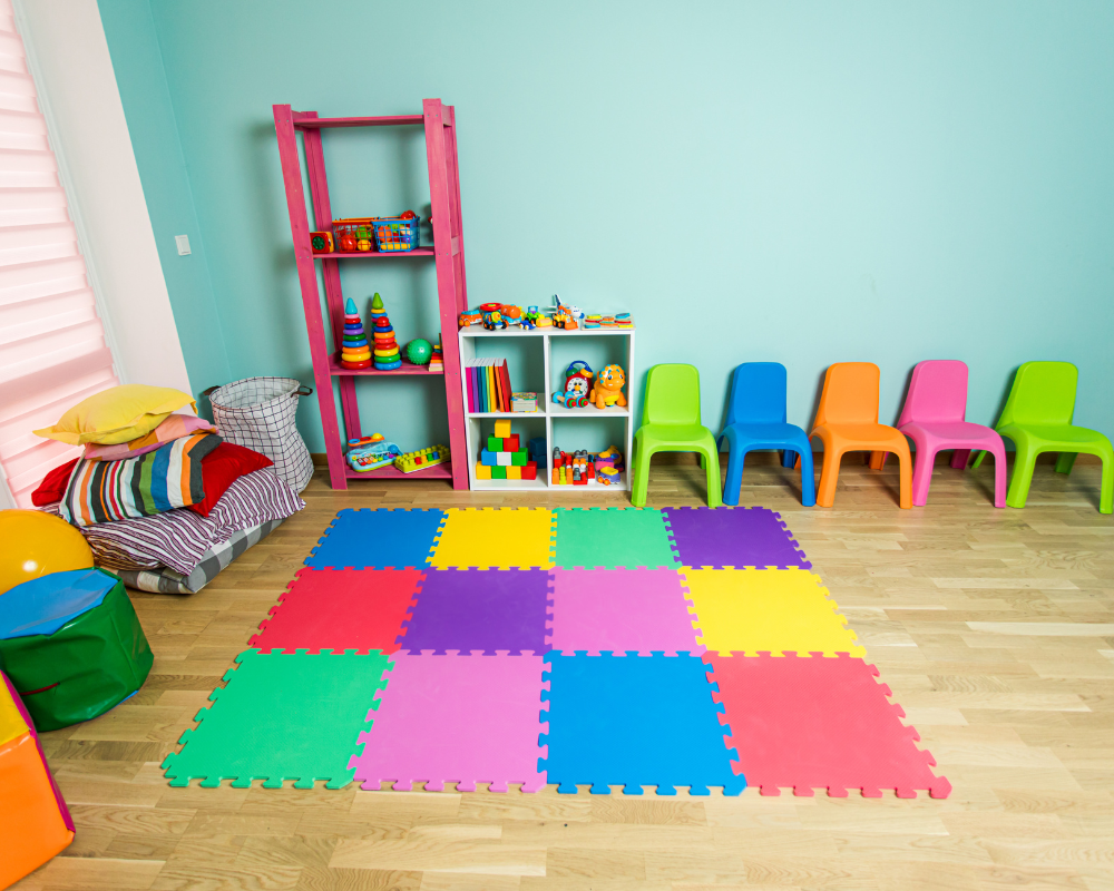Empty nursery classroom with bright coloured toys and furniture.