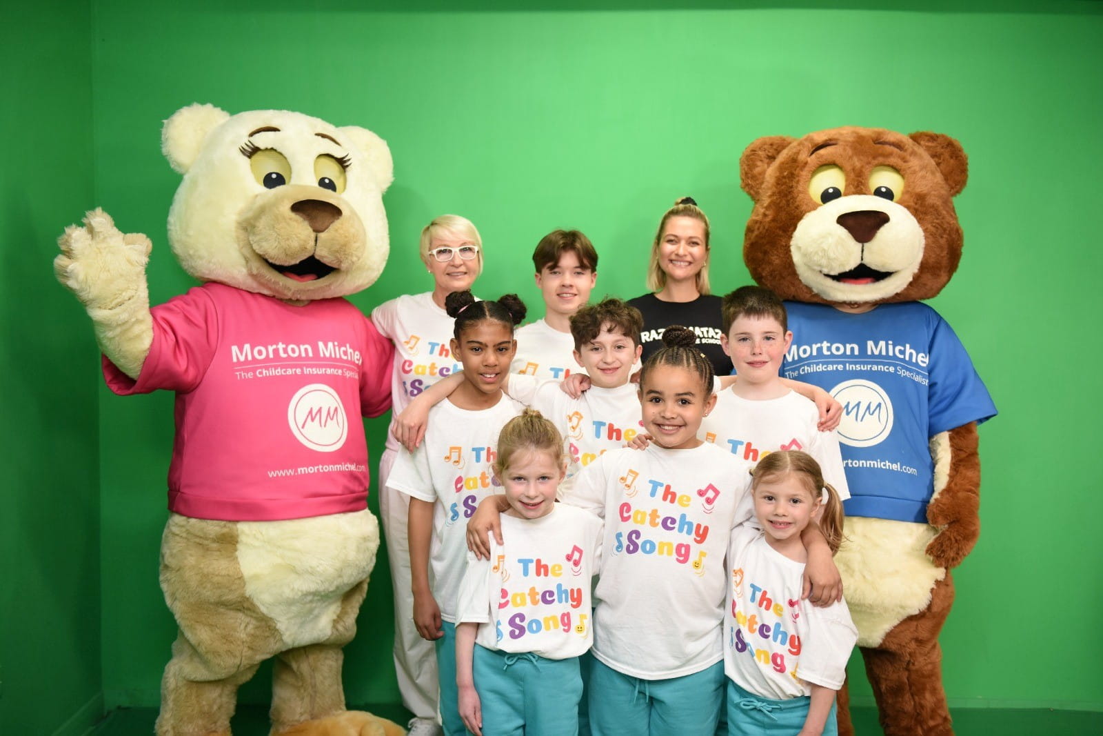 Morton and Michel the bears with group of children taking part in the official music video for The Catchy Song written and produced by The Catchees with vocals by Amanda Frolich