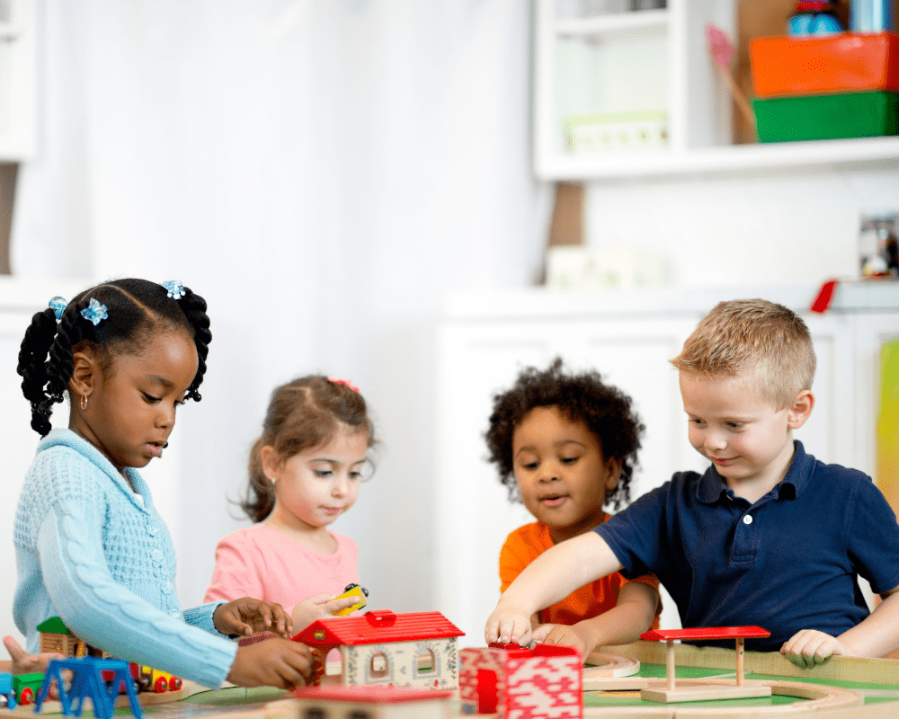 A diverse group of children playing in a preschool classroom 